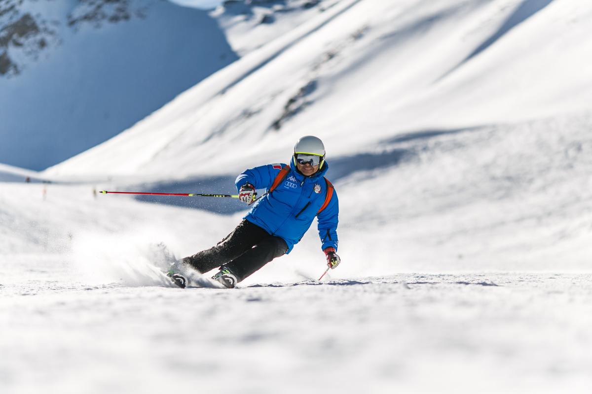 Man in blue coat snow skiing